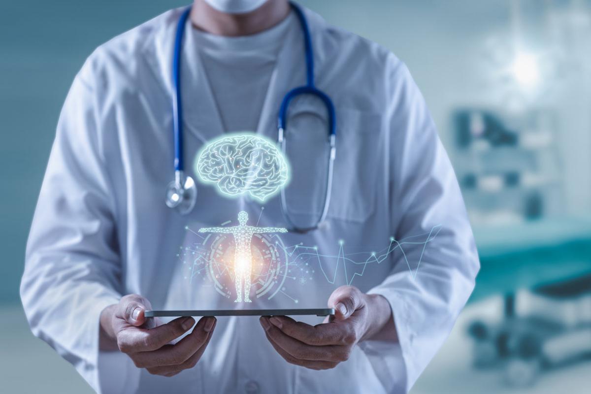 Doctor holding tablet showing brain, human and body anatomy